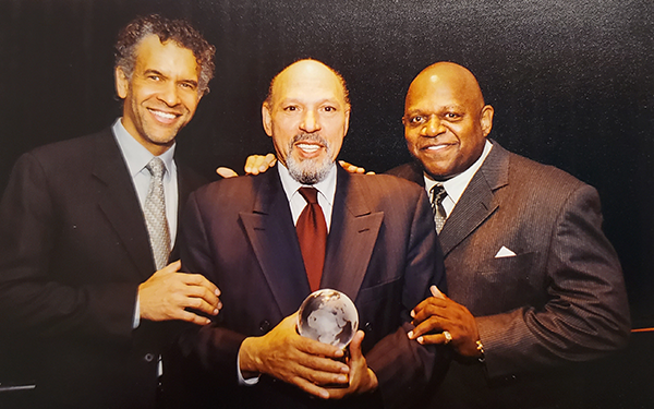 August Wilson, center, holding an award with actors, Brian Stokes Mitchell, left, and Charles S. Dutton, right.